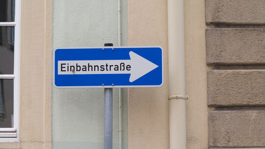 Traffic sign with the German text "Einbahnstraße" which translates into "One way" in English language Traffic sign with the German text "Einbahnstraße" which translates into "One way" in English language