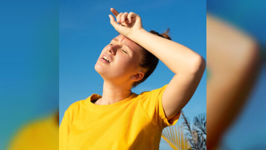 Girl is suffering from heat, woman with heatstroke. Having sunstroke at summer hot weather. Dangerous sun, girl under sunshine.