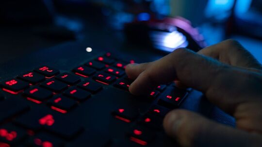 Mann tippt auf einer Tastatur