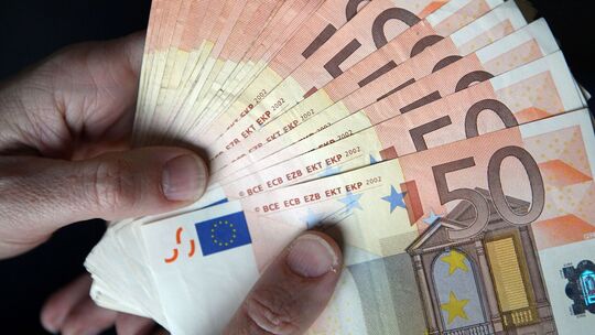 Person hält Geldscheine in den Händen