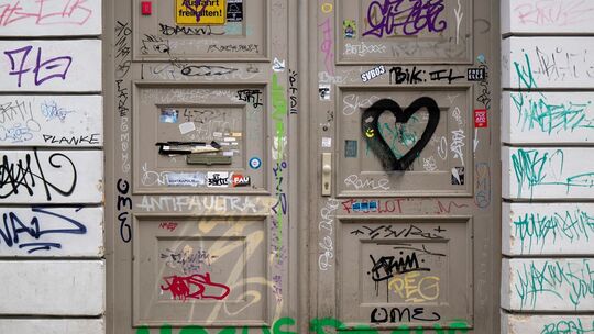 Eine Haustür ist mit Graffiti beschmiert