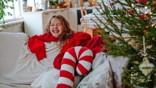 Mädchen lacht voller Vorfreude während der Weihnachtszeit