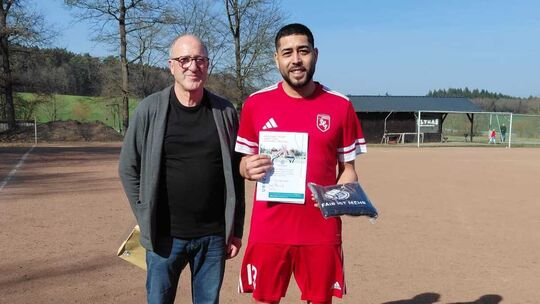 Spielleiter Hans-Jürgen Diel (links) überreichte Christian Forster, Spielertrainer der SG Dickenschied/Gemünden II, eine Urkunde