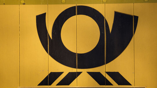 Ein Posthorn ist auf einem LKW vor dem Briefzentrum der Deutschen Post zu sehen.