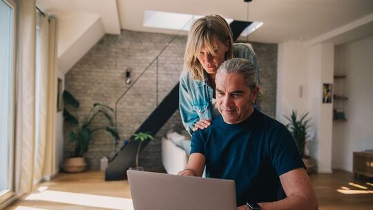 Paar schaut gemeinsam auf einen Laptop Paar schaut gemeinsam auf einen Laptop