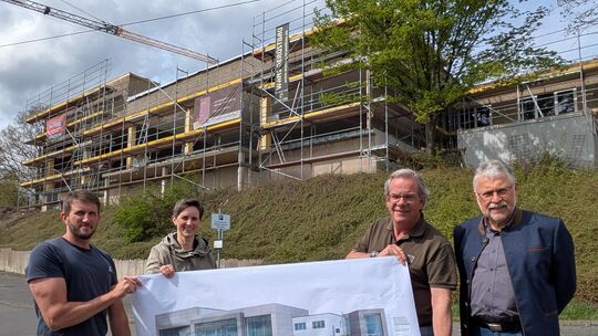 So wie auf dem Plan mit Alufassade, soll das Hallenbad in Zukunft aussehen. Bei der Besichtigung der Bauarbeiten dabei waren (vo