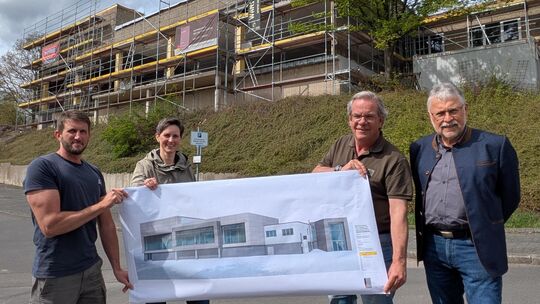 So wie auf dem Plan mit Alufassade, soll das Hallenbad in Zukunft aussehen. Bei der Besichtigung der Bauarbeiten dabei waren (vo