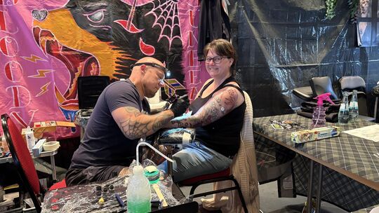 Diese Besucherin bringt ein dauerhaftes Souvenir von der Tattoo-Convention mit nach Hause.