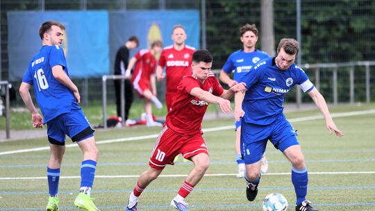 Der VfB Wissen (in Blau, von links mit Tom Zehler und Lukas Becher) setzte sich im Absteigerduell beim FV Rübenach um Marvin Gei