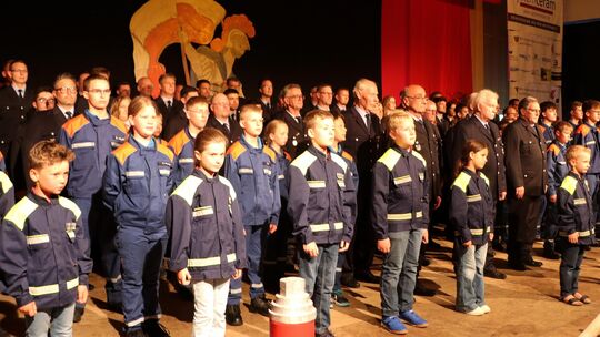 112 Jubilare der Freiwilligen Feuerwehr Nentershausen, im Alter von 6 bis 86 Jahren, präsentieren sich dem Publikum beim Kommers