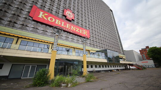 Die Natur breitet sich am Eingang zum verlassenen Königsbacher Brauereigelände aus, Unkraut wuchert.