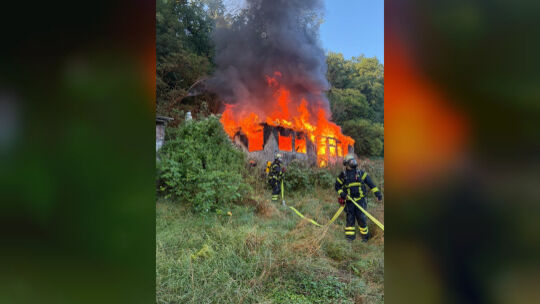Feuerwehrleute im Einsatz: Ein brennendes Gartenhaus in Rüdesheim droht auf ein nahe gelegenes Waldstück überzugreifen. Feuerwehrleute im Einsatz: Ein brennendes Gartenhaus in Rüdesheim droht auf ein nahe gelegenes Waldstück überzugreifen.
