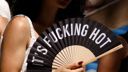 «Its Fucking Hot» steht auf dem Fächer einer Frau