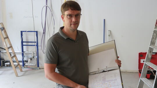 Architekt Bastian Heer erläutert den Fortgang auf der Baustelle.