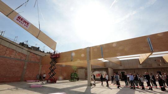 Beim Richtfest des neuen Rewe-Markts in Koblenz-Rauental wird ein 9 Tonnen schwerer Holzbinder von einem Riesenkran auf seinen k Beim Richtfest des neuen Rewe-Markts in Koblenz-Rauental wird ein 9 Tonnen schwerer Holzbinder von einem Riesenkran auf seinen k