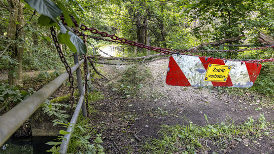 Eisenketten und Warnschilder sperren die Brücke über den Mühlengraben bei Heuzert: Der Anlieger beansprucht das Bauwerk als sein
