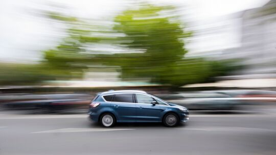 Auto fährt innerorts über eine Straße